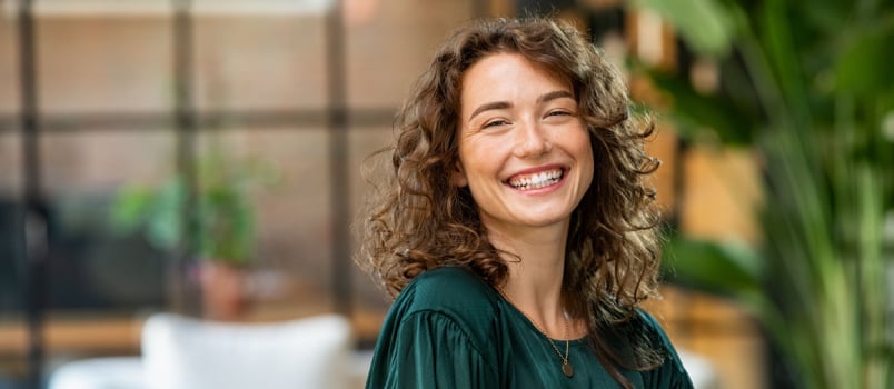 Young smiling woman looking into camera 