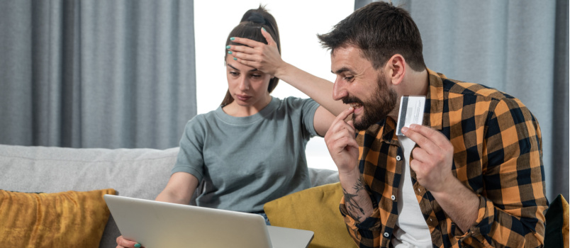 Young couple checking online expenses 