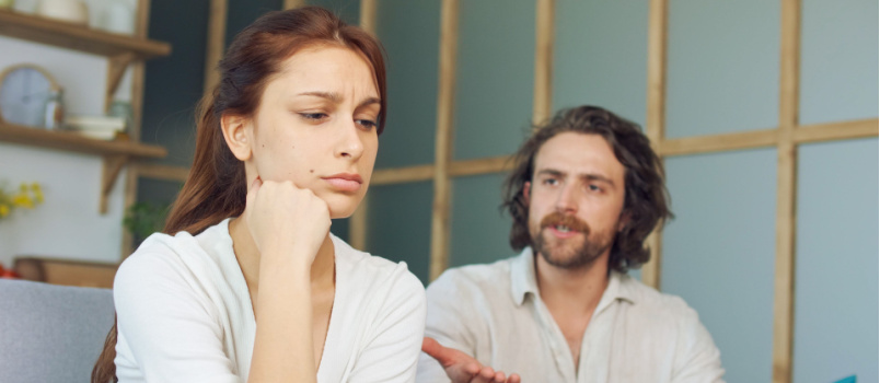 couple quarreling sitting on couch