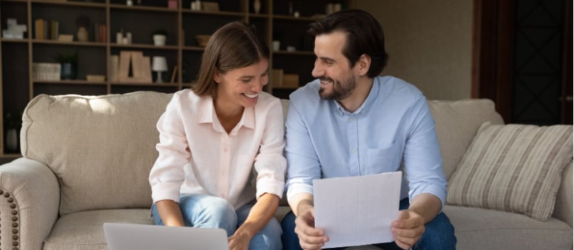 Happy couple doing finance calculation