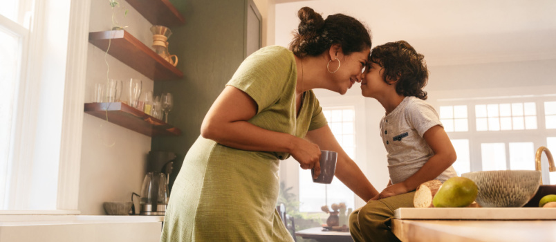 Mother touching noses to her young son 