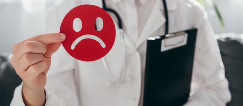 Doctor holding sad smiley