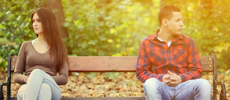 Young couple quarrel sitting on bench