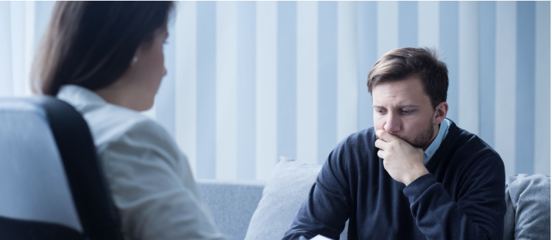 Sad man having psychology session