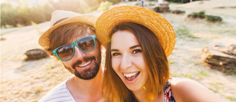 Happy travelling couple taking selfie 