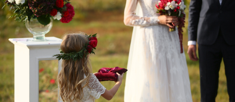 Little girl carrying wedding rings 