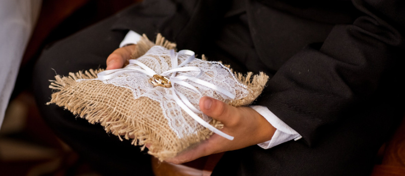 Boy holding gold wedding ring