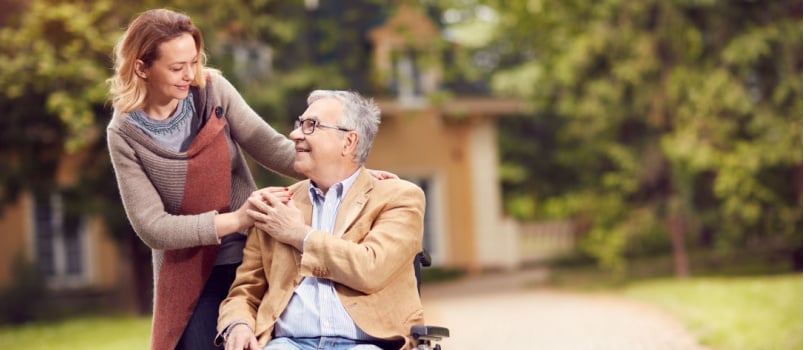 Senior man on wheelchair caring daughter
