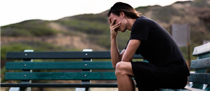 Stressed mother sitting on bench