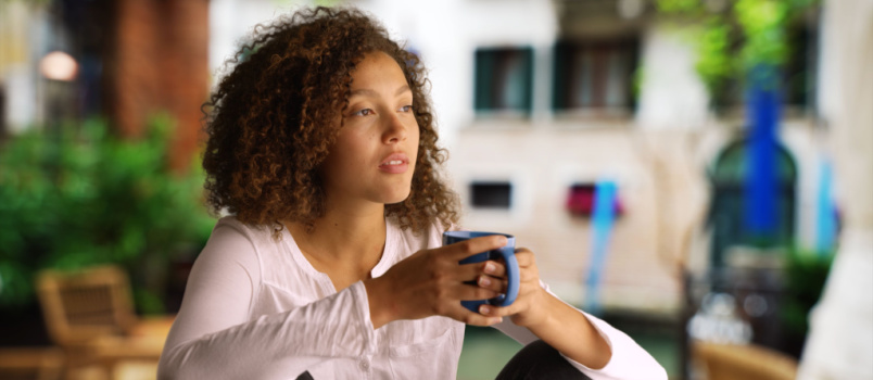 Black woman sitting having coffee
