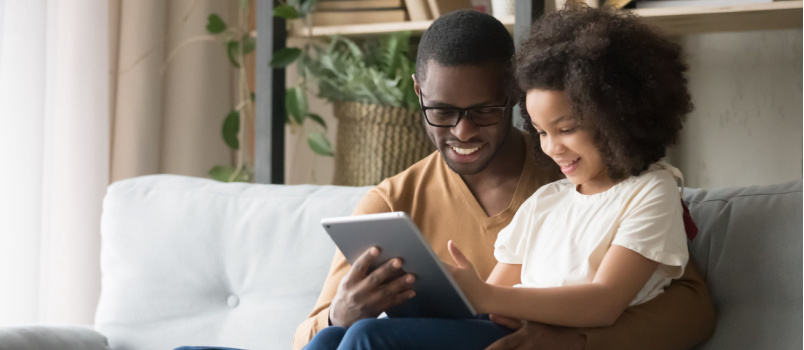 Dad and son reading e-book together 