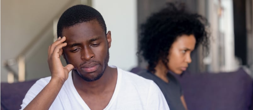 Unhappy couple sitting on couch