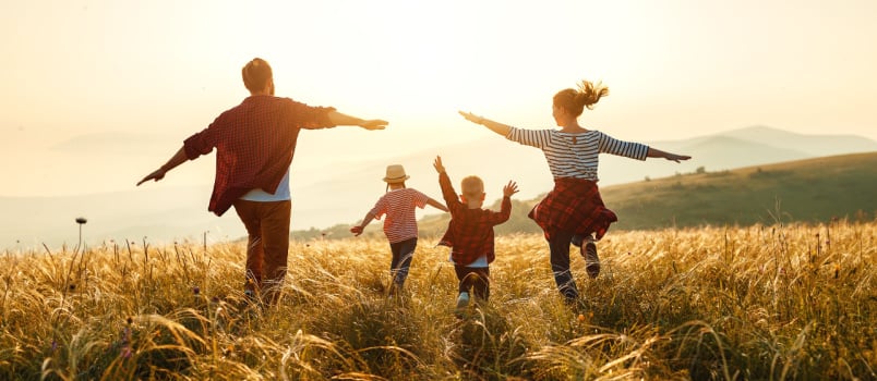 Happy family walking in field