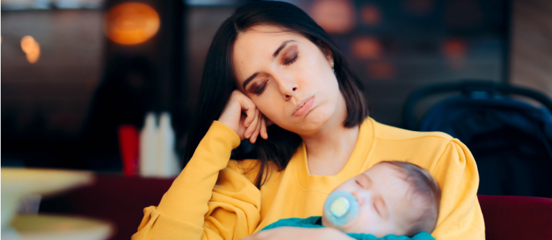 Mother holding sleeping baby