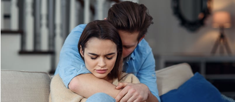 Man comforting woman