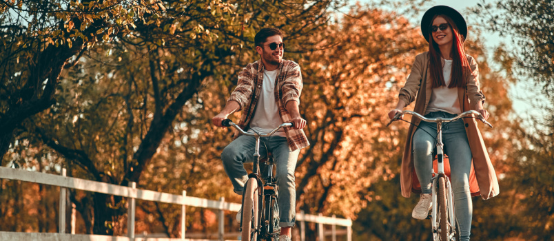 Couple cycling in city 