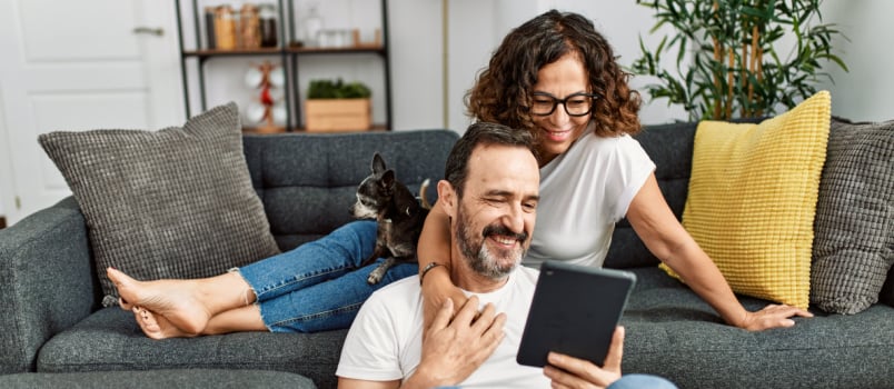 Middle age couple smiling looking in something