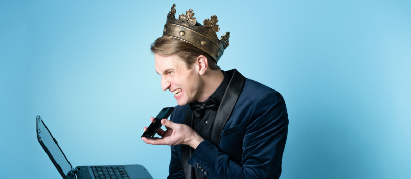 Frustrated man talking on phone while working