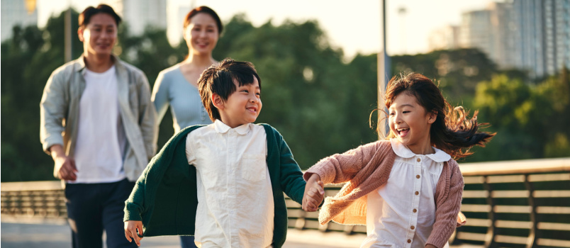 Happy asian family walking in city