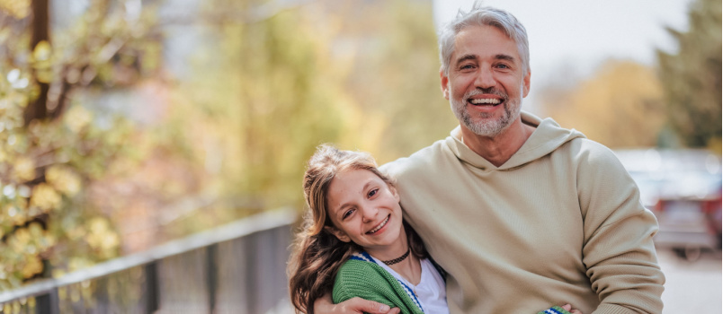 Father and daughter walking on street 