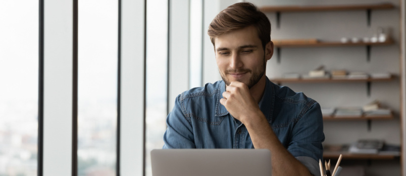 Happy man reading the new year wishes