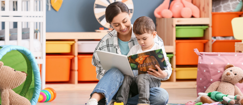 Little boy reading interesting book