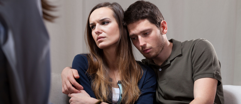Sad couple taking psychotherapy