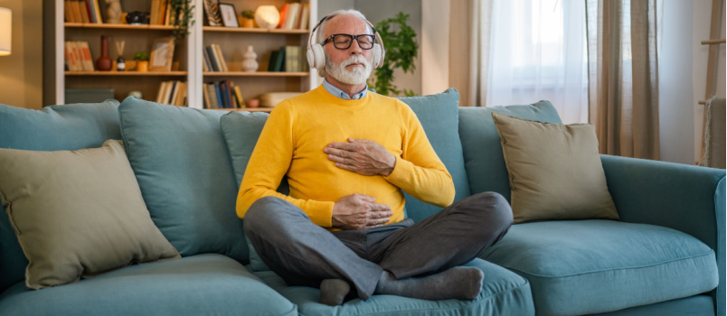 Mature man sitting peacefully listening music