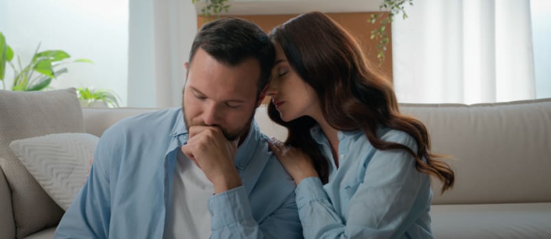 Sad couple sitting in couch