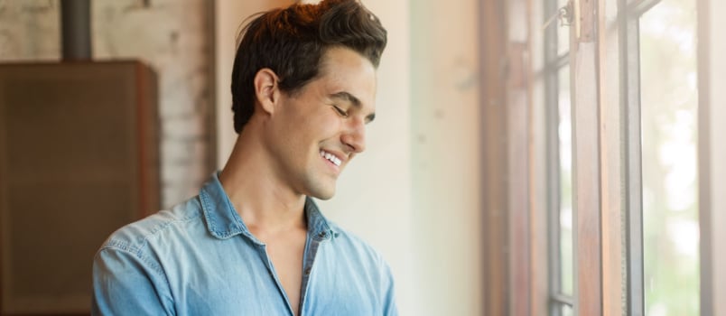 Man smiling while texting