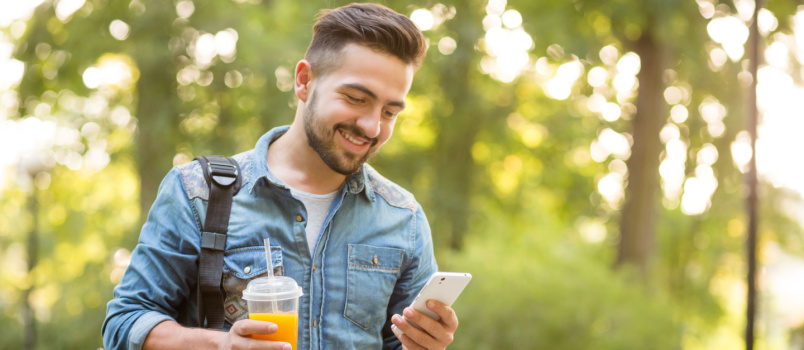 Happy man walking in park
