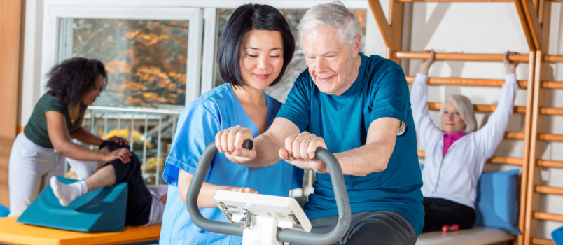 Nurse helping elder man in hospital