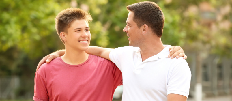 Father and son walking on street