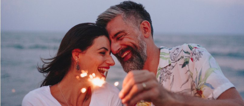 Couple celebrating near beach