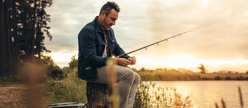 Man sitting beside river