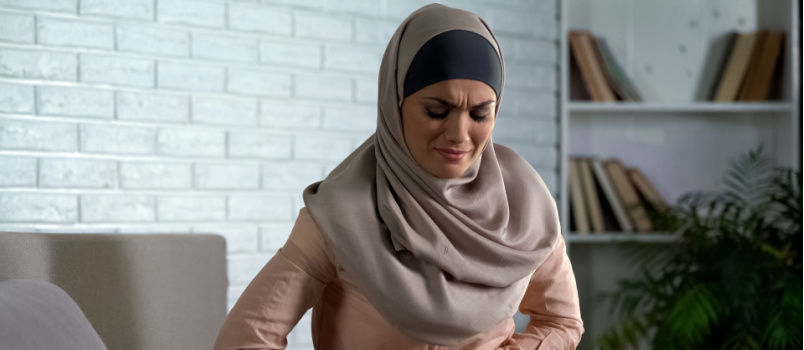 Woman suffering from abdominal pain