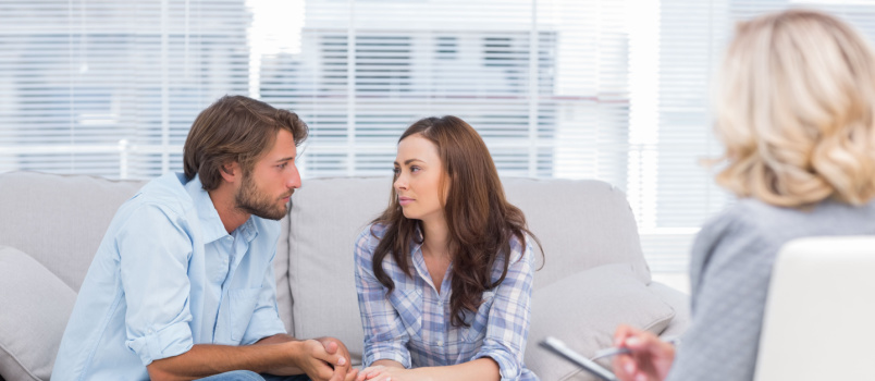 Young couple looking at each other during therapy session