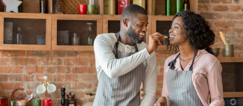 Young man feeding his wife