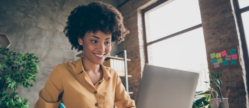 Cheerful woman using laptop