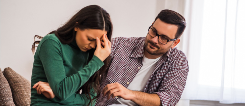 Man comforting sad woman