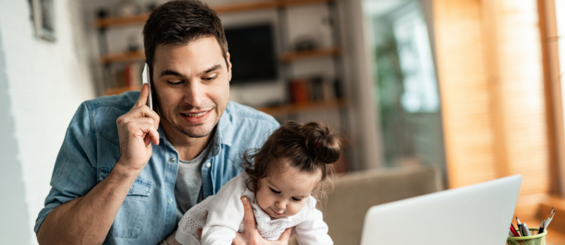 Young working father talking on phone
