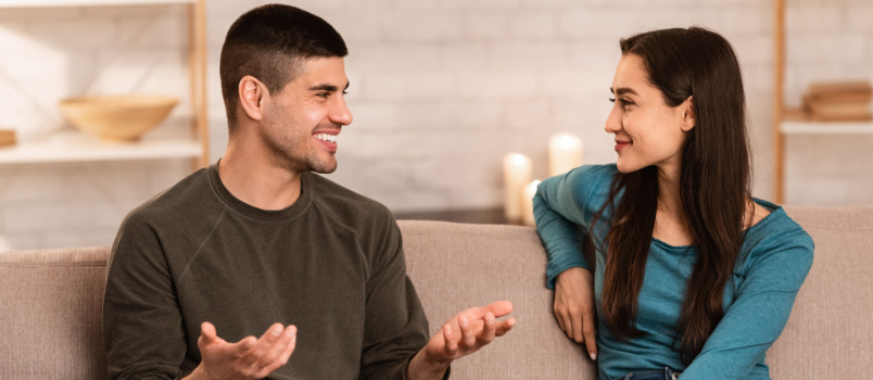 Couple sitting on couch talking