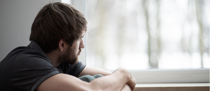 Young man sitting on floor