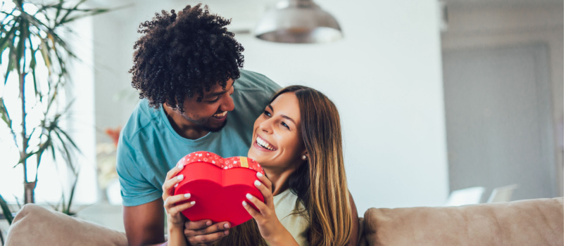 Man giving surprise gift to her girlfriend