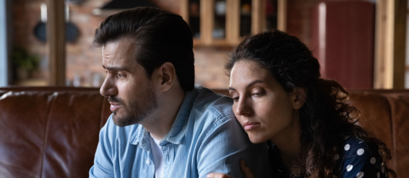 Wife comforting sad man