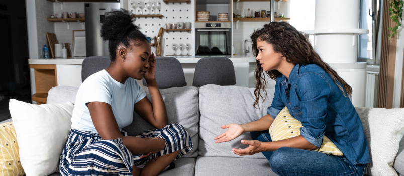 Sad depressed woman having conversation with friend