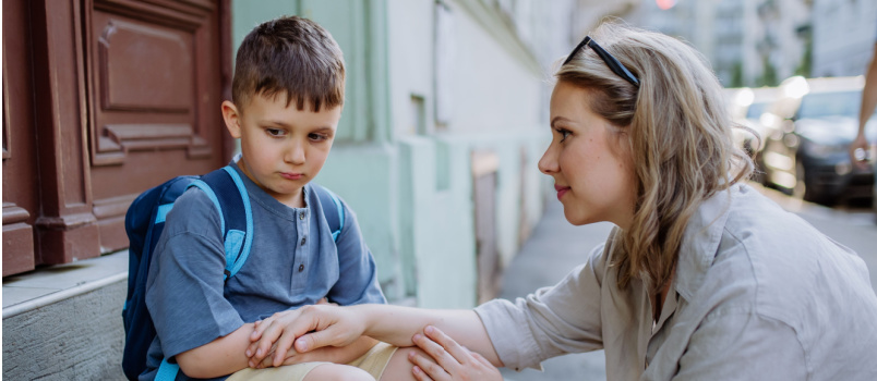 Mother consoling her little son