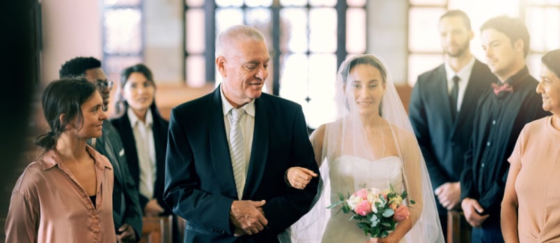 Bride walking with father in church