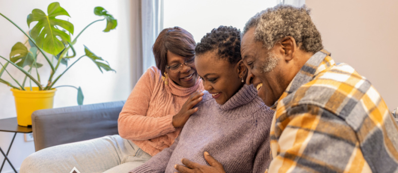 Retired parents with their pregnant daughter