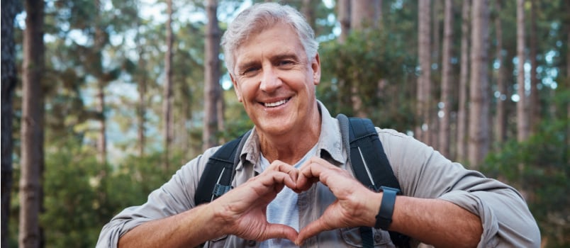 Senior man hiking in forest